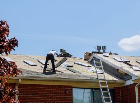 Home roof construction applying roof new shingles in apartment building